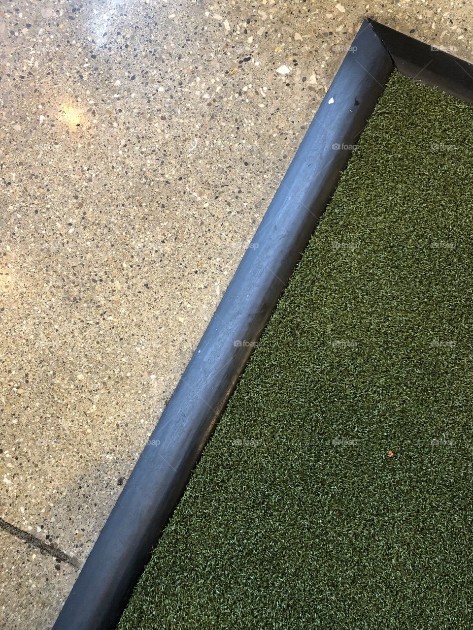 Fake grass and polished concrete