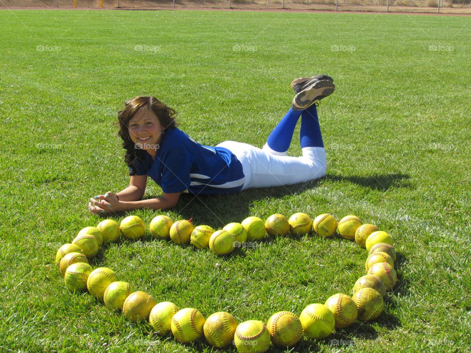 Avery loves softball. picture day at the softball field