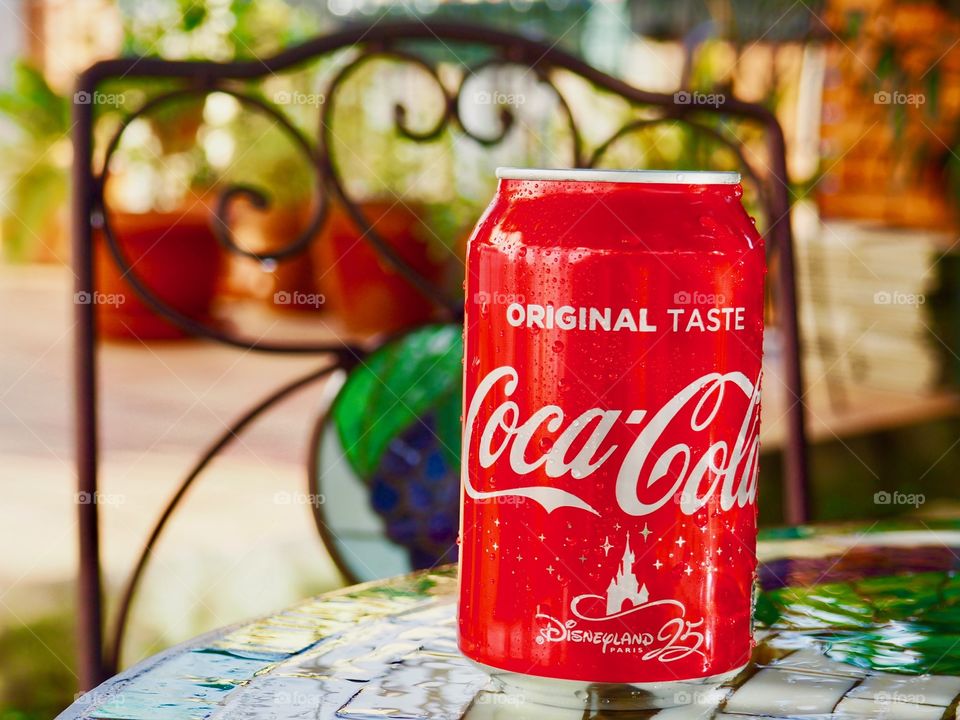 Coca cola can on garden table.