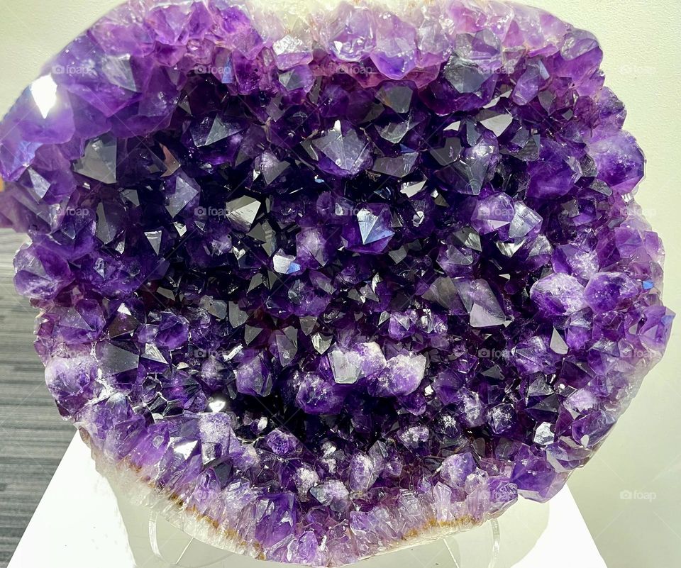 Amethyst crystal geode on display. A vibrant, beautiful  semiprecious stone often used  in jewelry. 