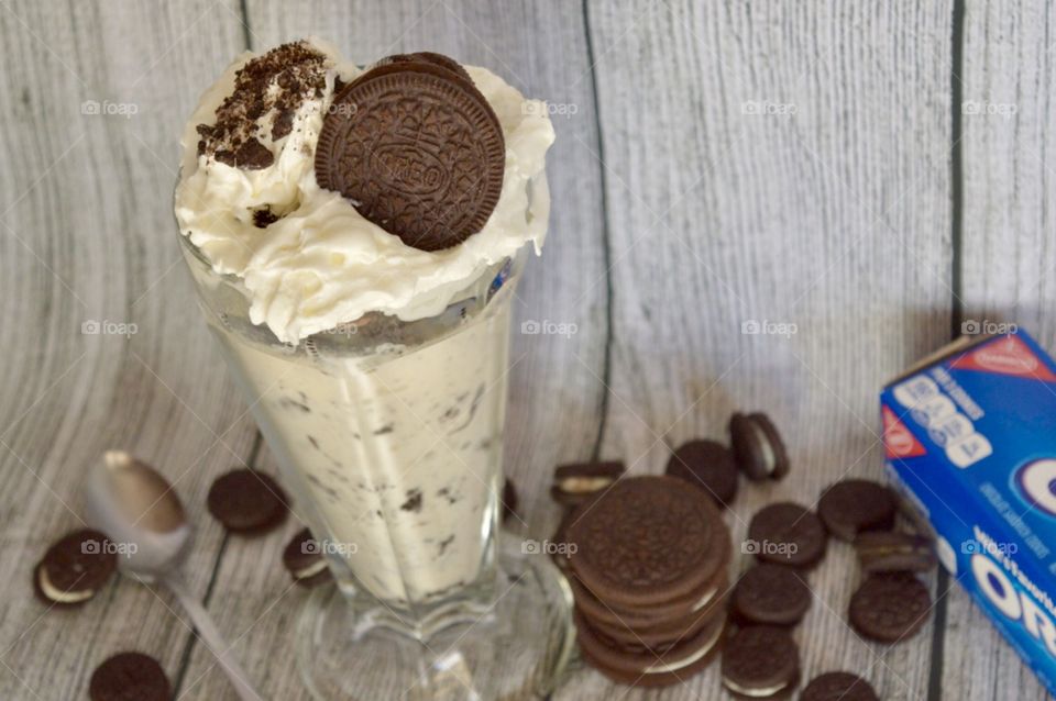 Oreo cookie milkshake with a wooden rustic white background