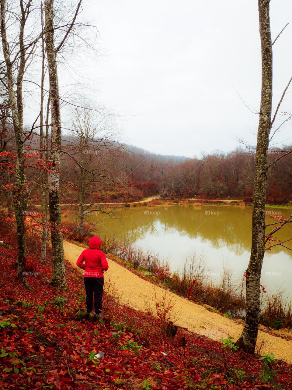 red weared girl looking the lake