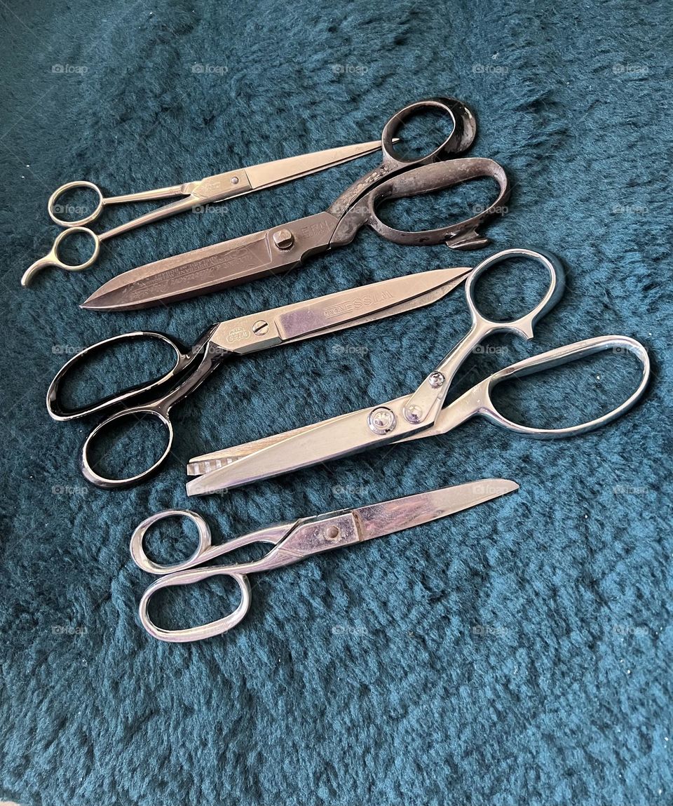 A collection of dress makers scissors second top pair made in Germany Hooper & Harrison Pty Ltd Sydney Melbourne Adelaide and Hobart ERN Solingen has a crown and sword and Germany on one side a beautiful pair to cut with 