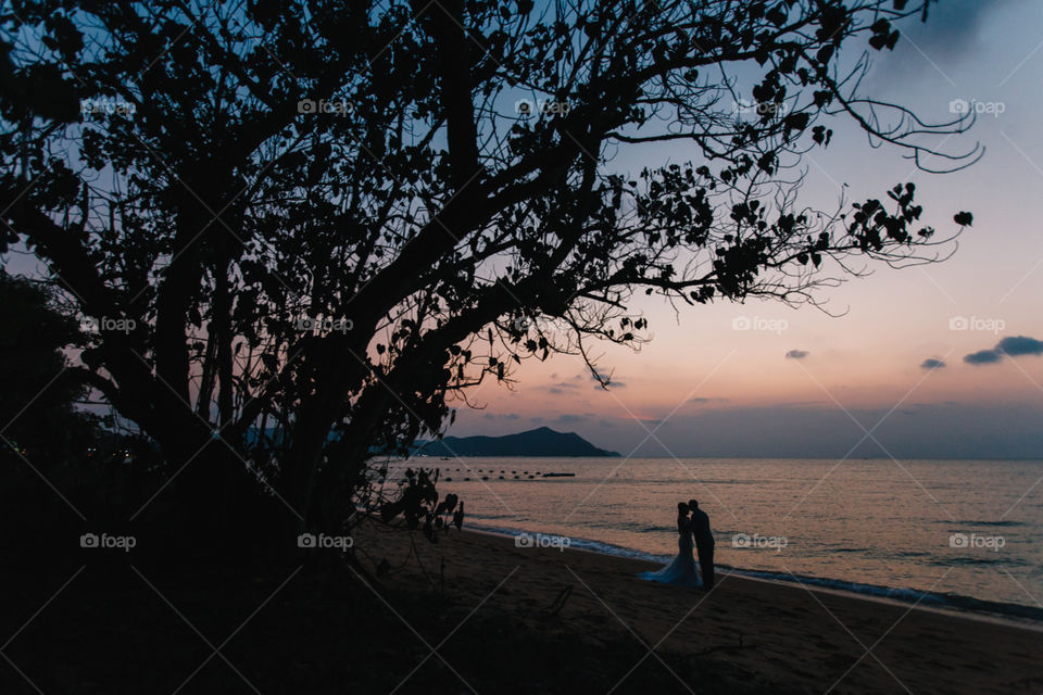 Silhouette of Wedding Couple on a beach and sunset.