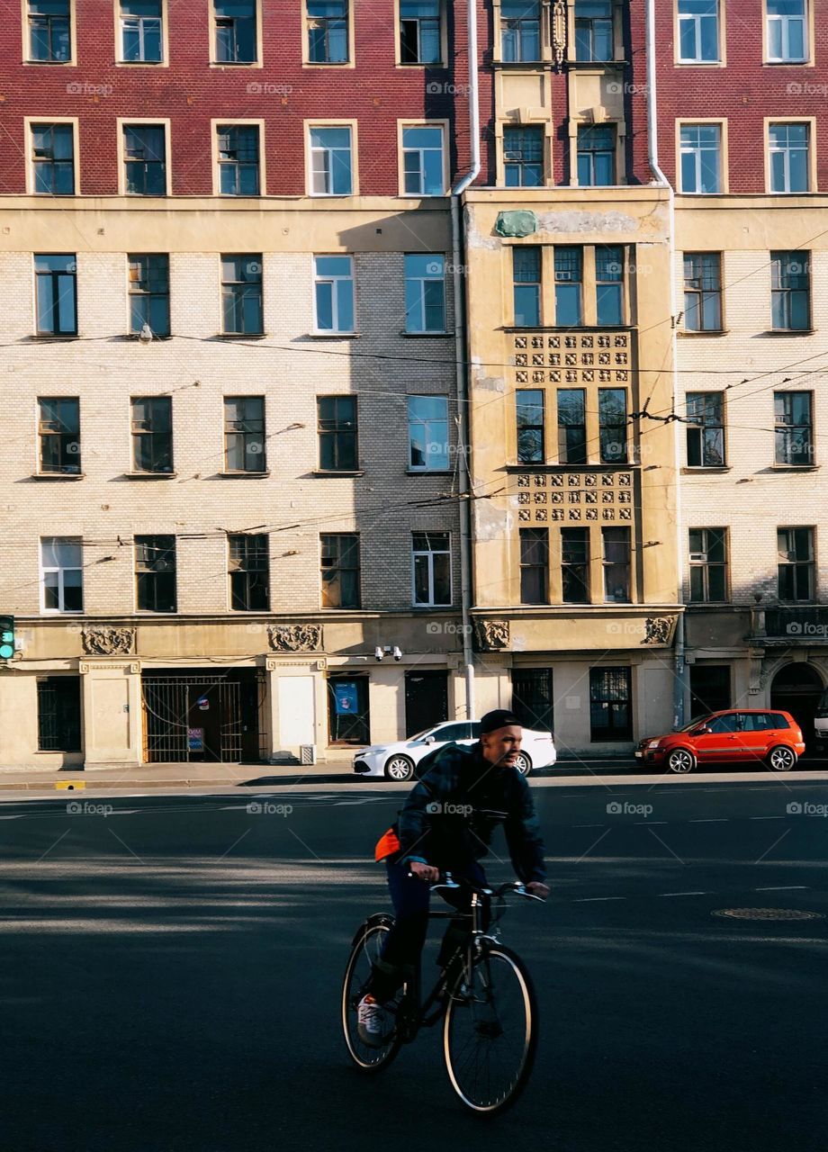 Young male on bicycle in sunny spring day