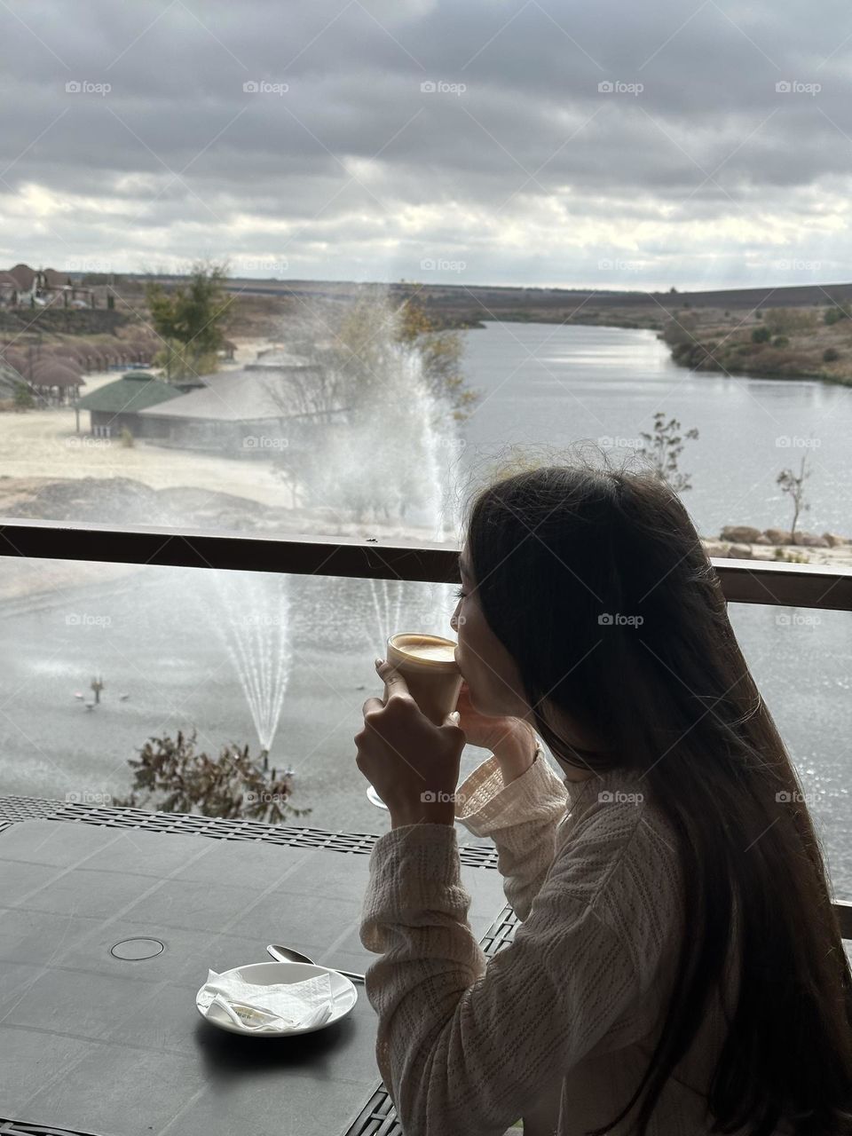 A cup of delicious coffee against the backdrop of the lake