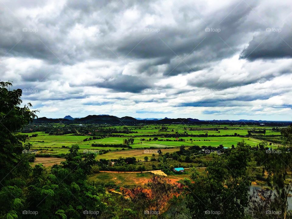 Good Green field View in landscape with Cloudy sky. Countryside in Thailand. 