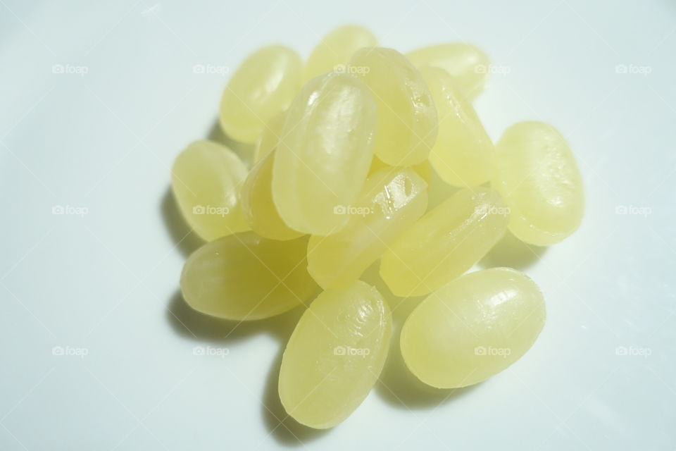 Closeup of honey candy on the white dish.
