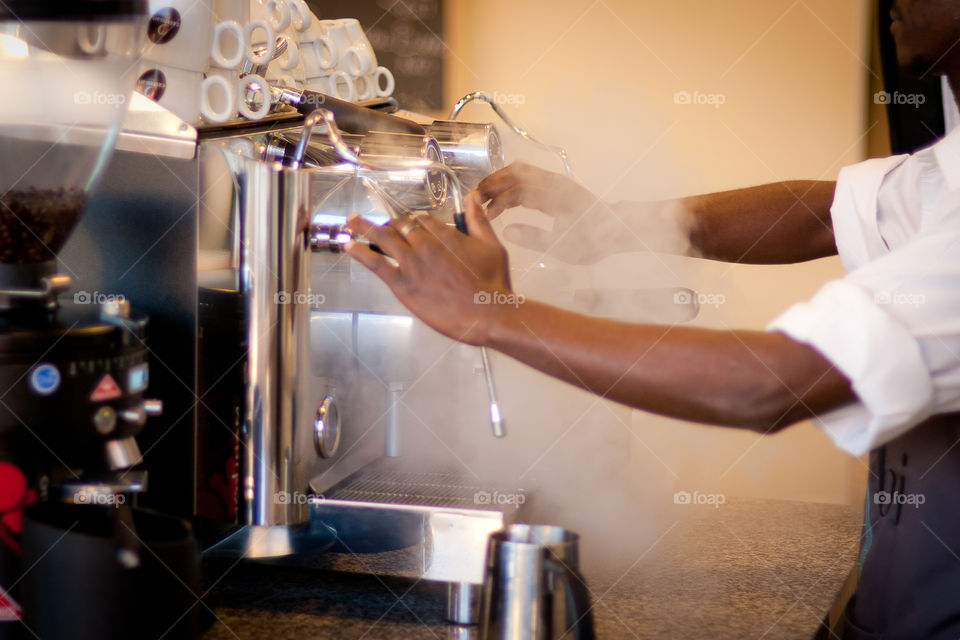 Making coffee on the espresso machine with steam