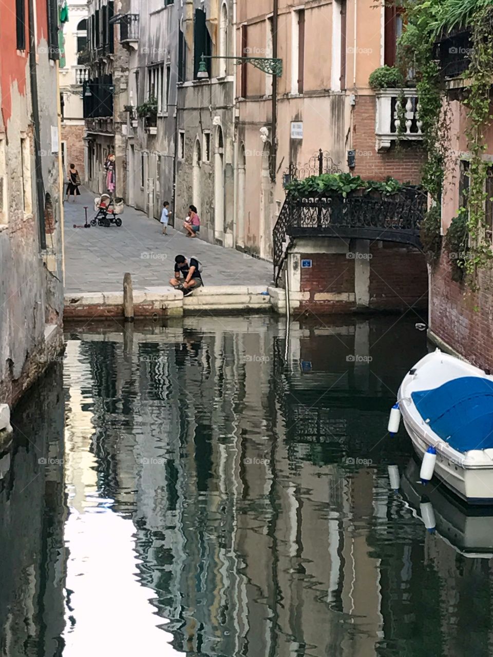 Peaceful reflection by a Venetian canal