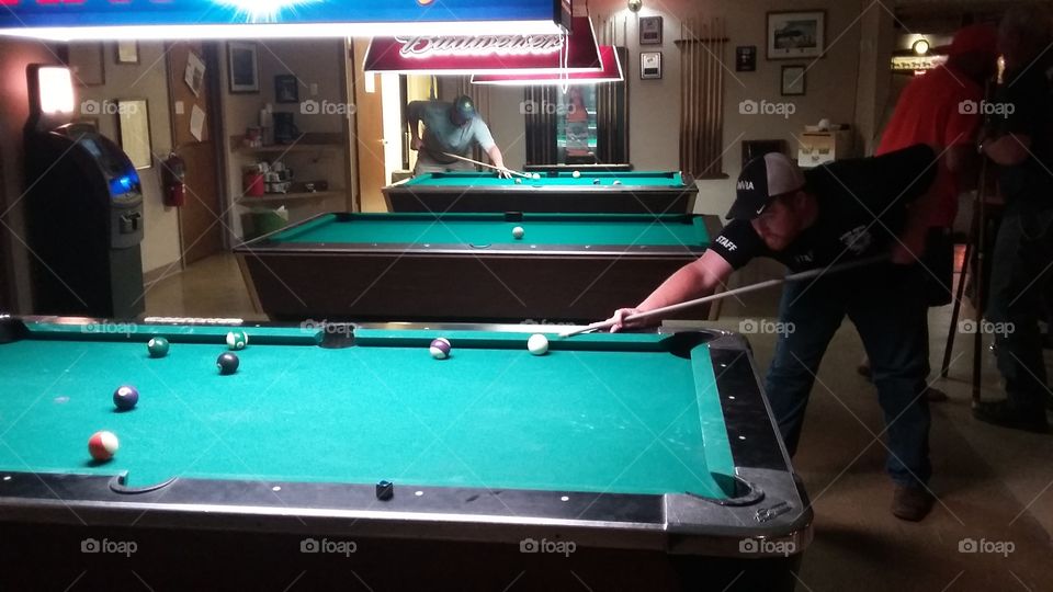 Young man playing billiard