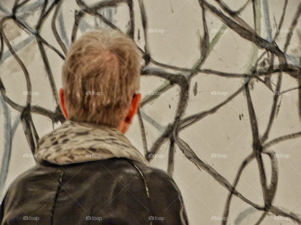 Older Woman Viewing Art In A Museum