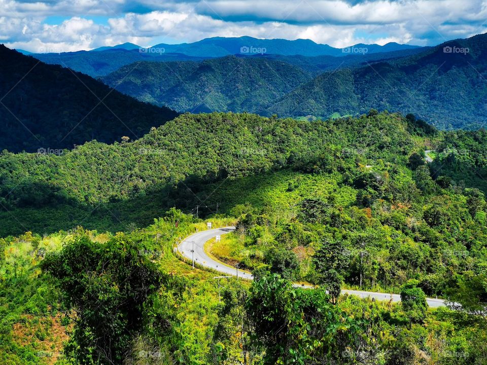 Winding mountain road in Doi Phu Kha National Park in Nan, Thailand. This road snakes its way through the park and takes around 5 hours to complete.