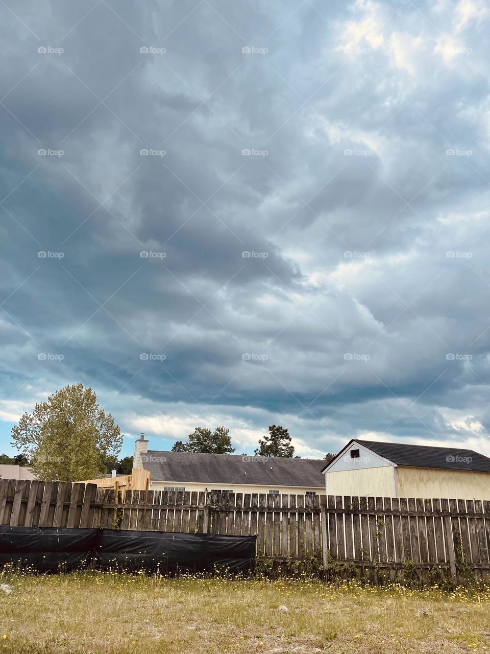 Wild, vivid Storm clouds rolling in over a backyard on a very warm Spring Day in North Carolina. 