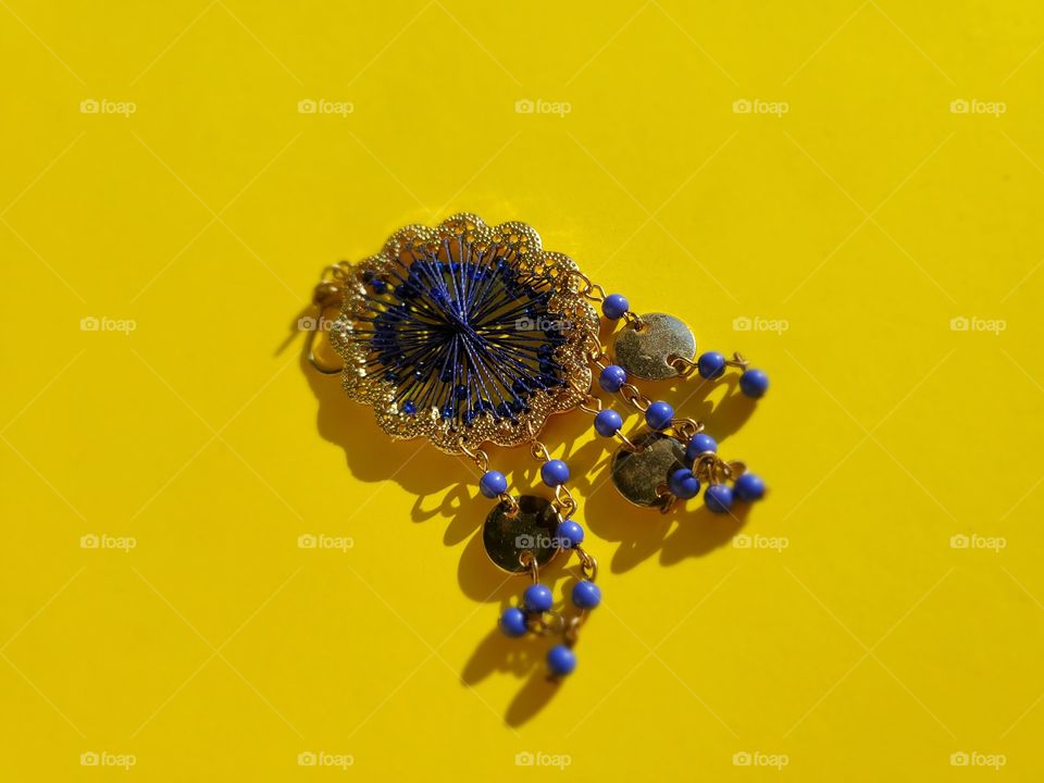Bohemian dark blue earring with bright bold yellow backdrop