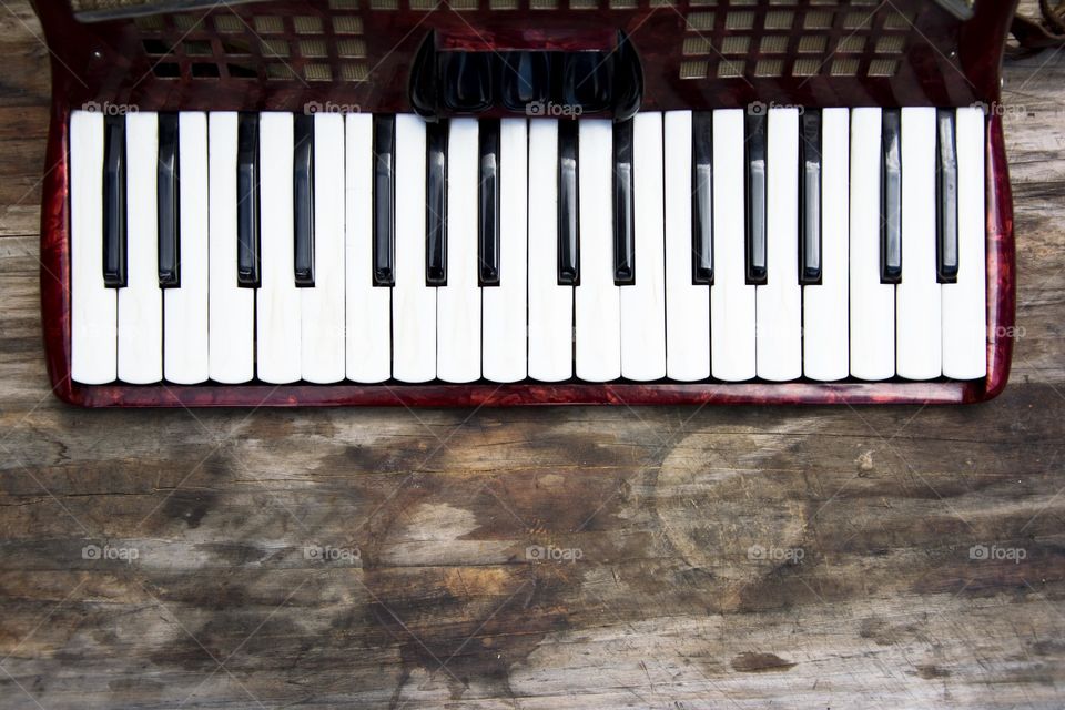 accordian keyboard. accordian keyboard on a wooden background