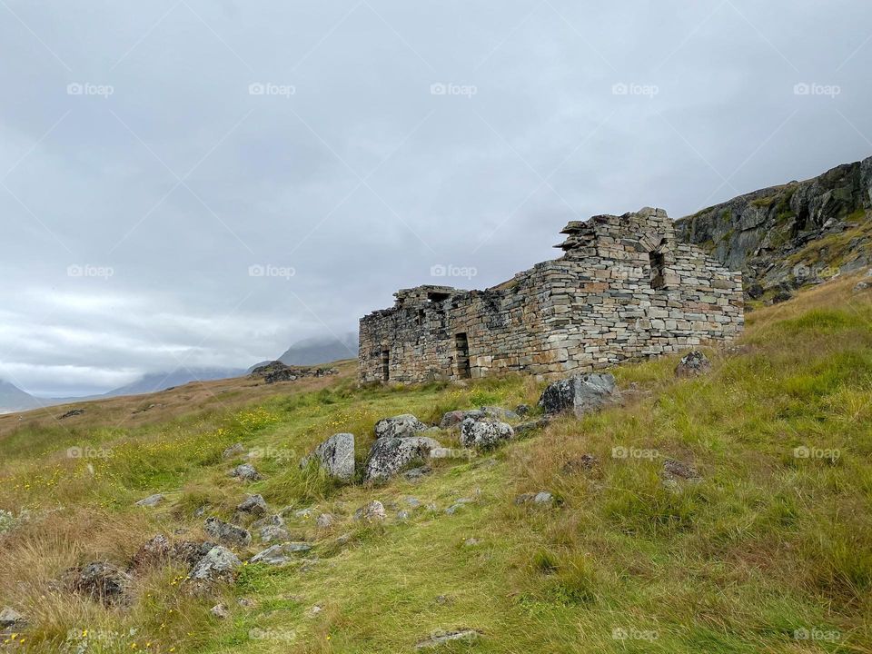 A grassy hill with the remains of a Viking church