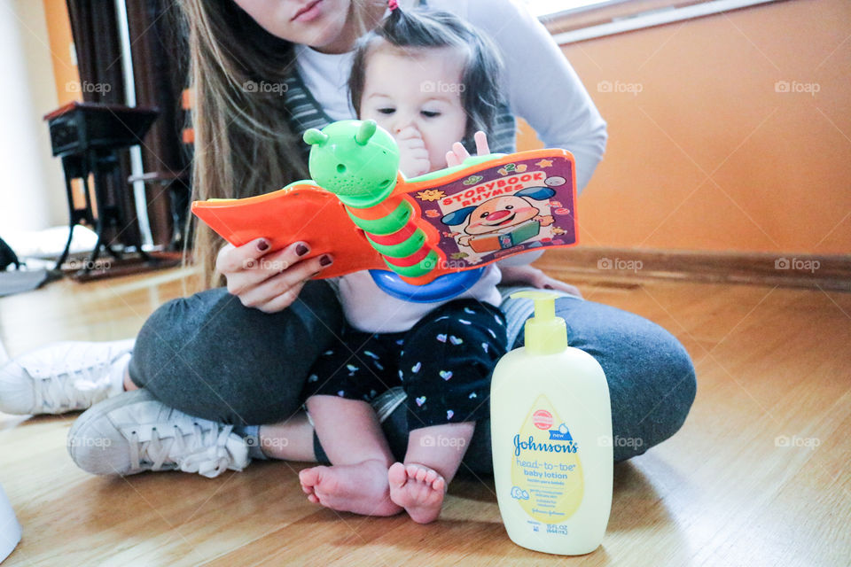 Johnson’s Baby Care- woman and child reading a book . 