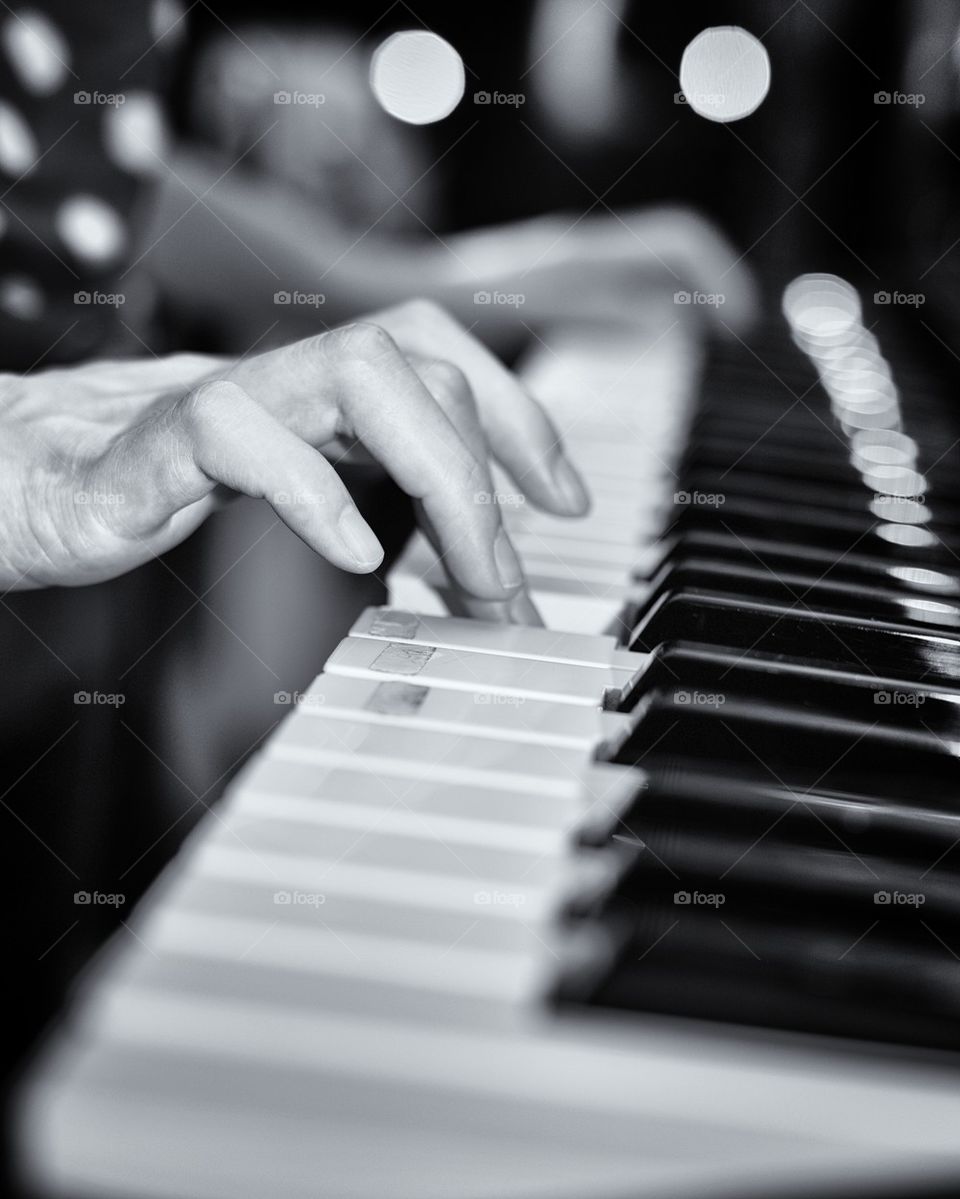 Woman's hands playing piano