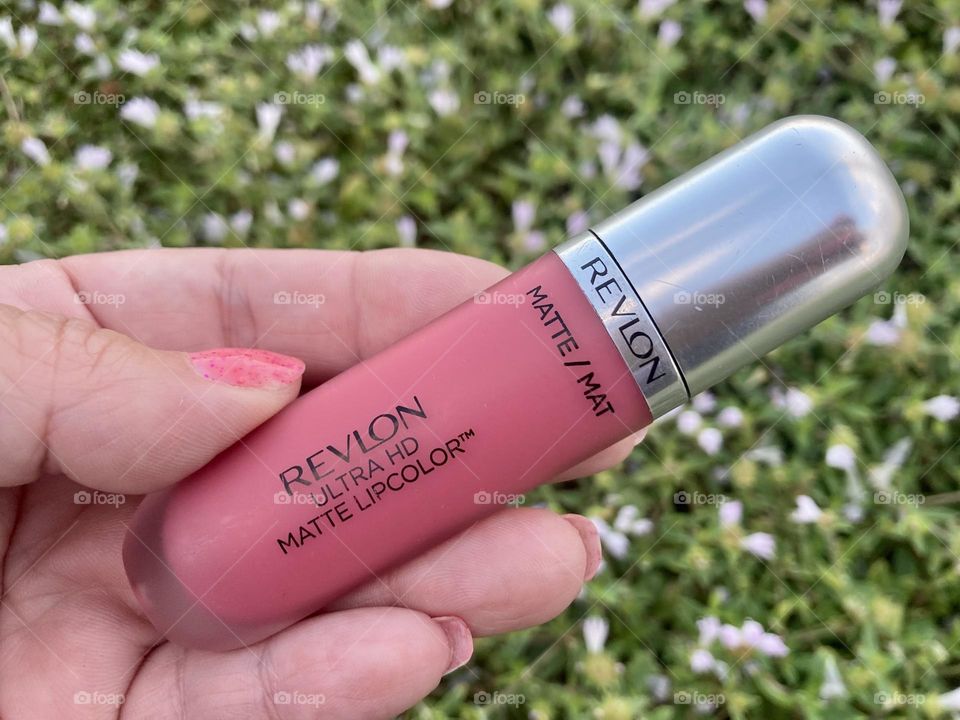Revlon lipgloss in flowers and in hand