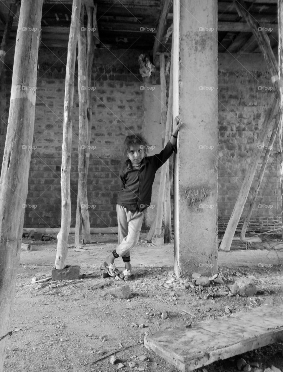 Photographs of a boy/photos of a poor boy standing/photos of a lonely boy/photos of a cute little boy /photos of an Indian child/photos of a cute child while waiting/black and white photo/indian boy black and white phot