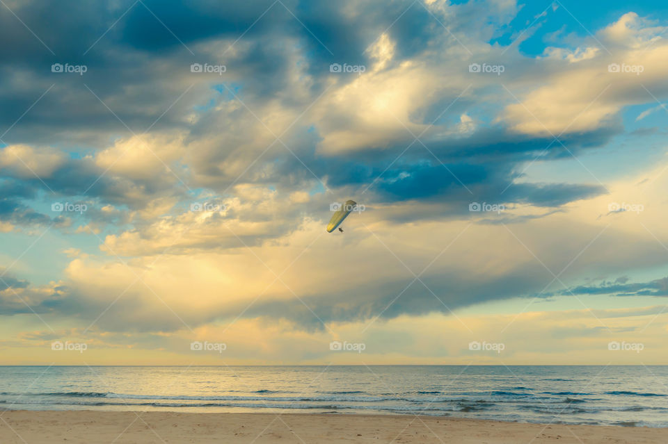 Seascape with glider during sunset.