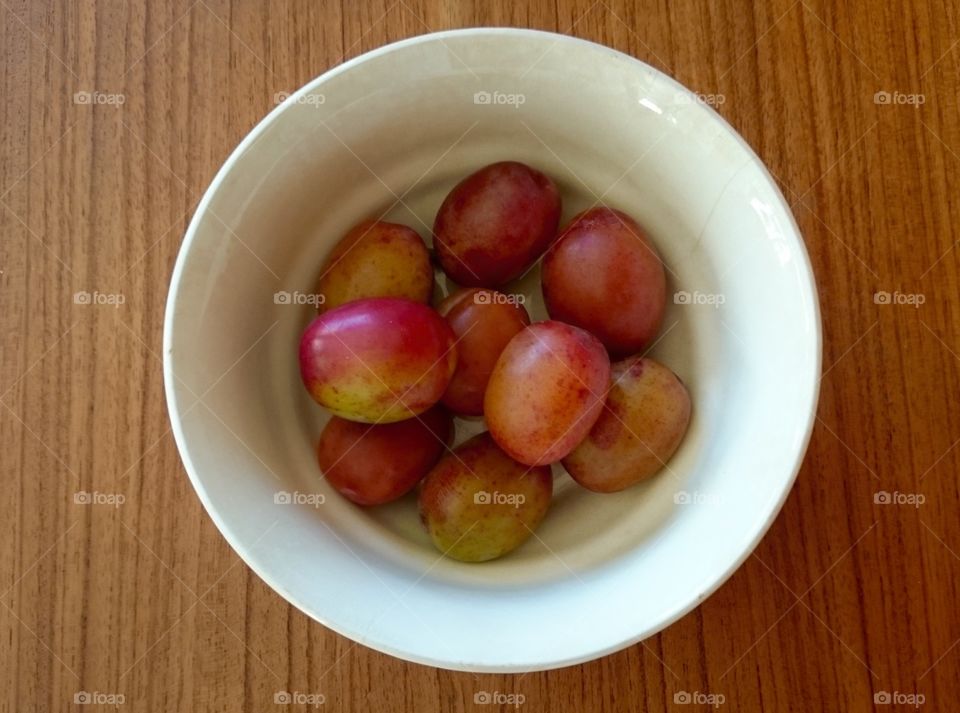 A bowl with plums. A bowl with plums