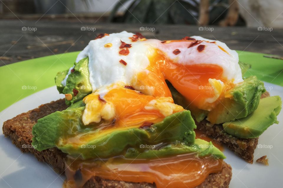Avocado and poached egg on rye toast 