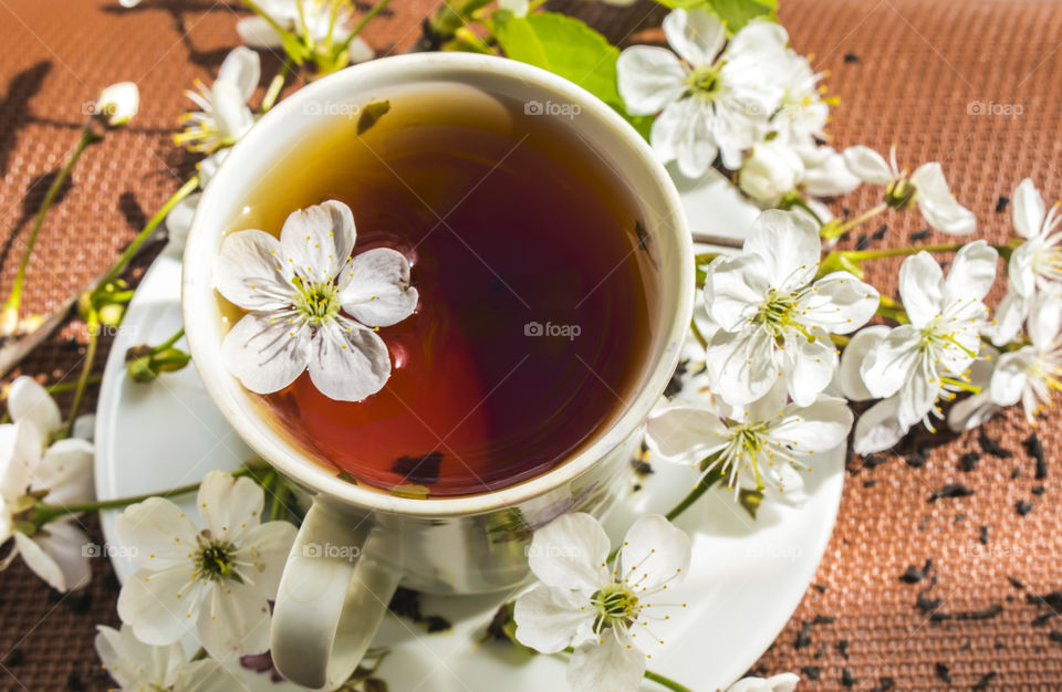 Hello summer! Summer tea with flowers. The sun is in the frame.