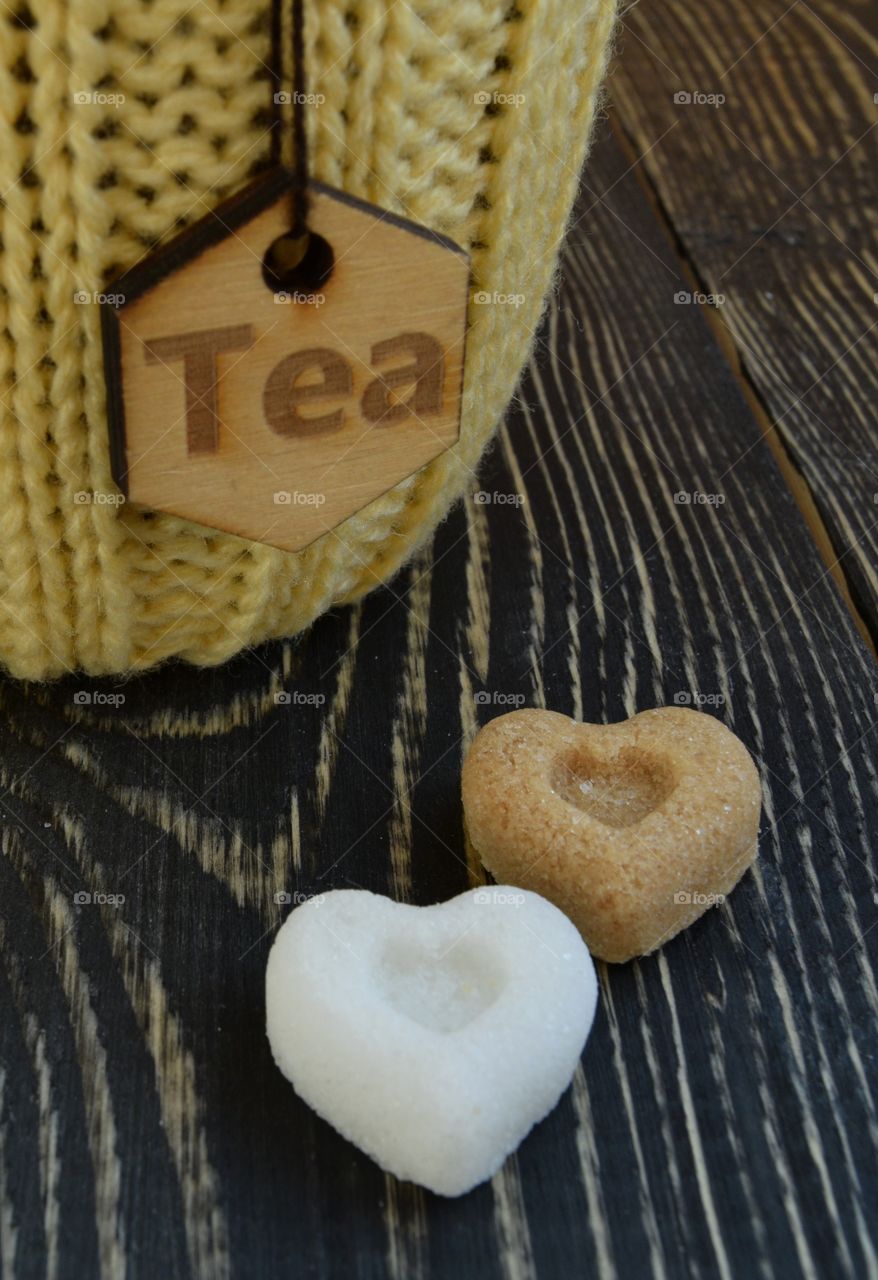 Sugar in form of heart on wooden background 