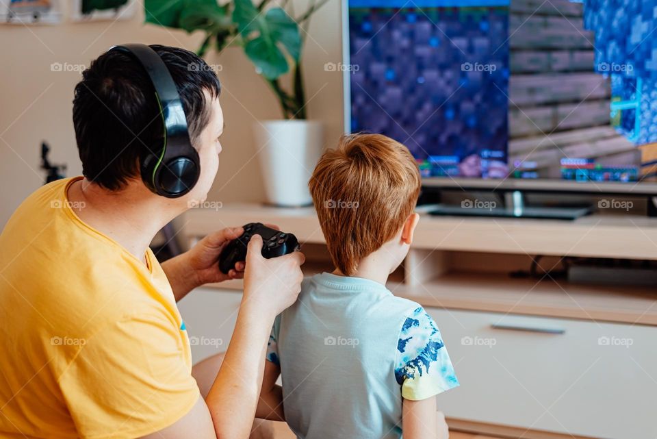 Boy and dad playing video game 