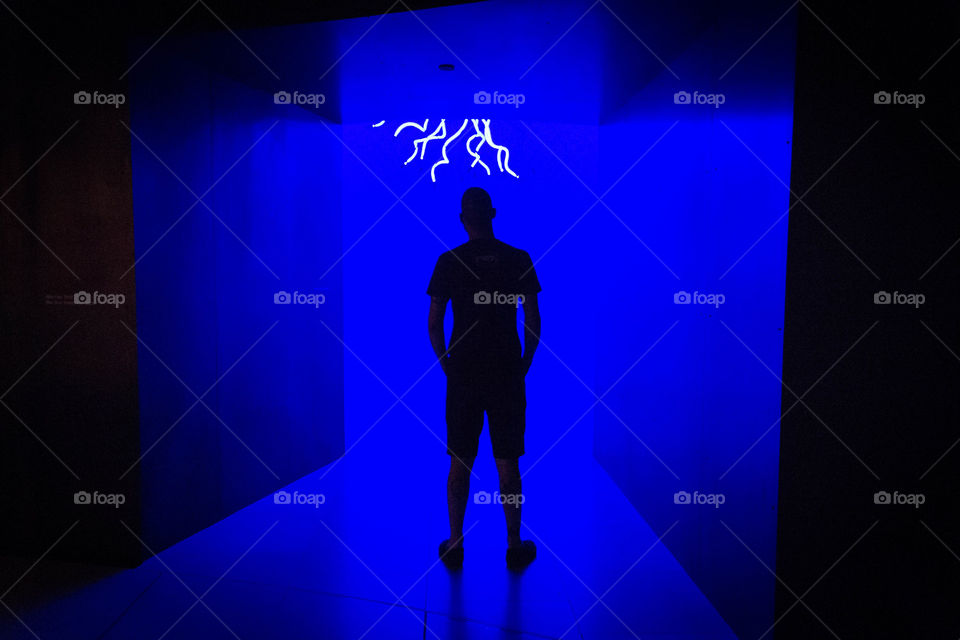 Silhouette of a man in blue lights