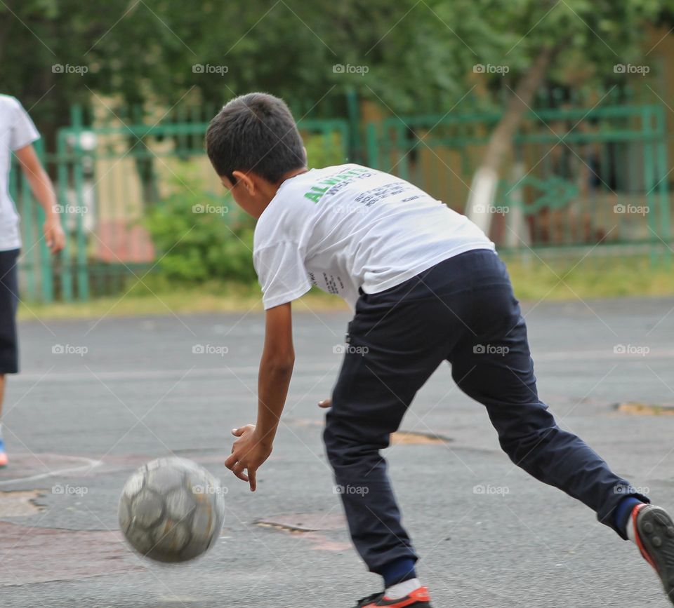 children in the old stadium playing football