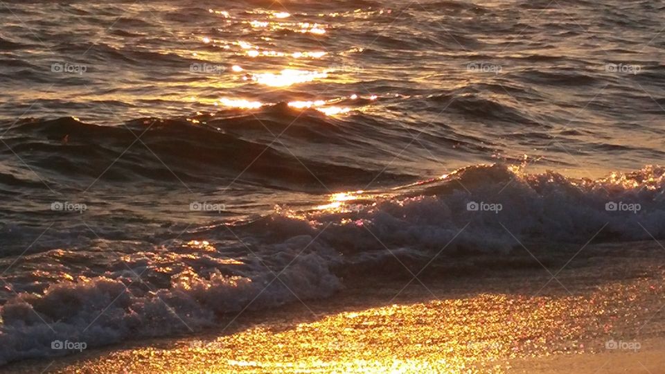 sun and waves at sunset