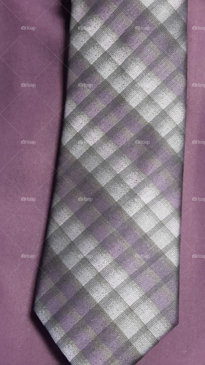 purple shirt and necktie