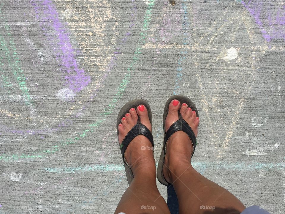 My feet standing near sidewalk art