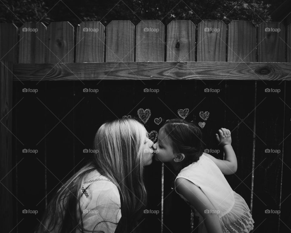 Close-up of mother kissing her daughter