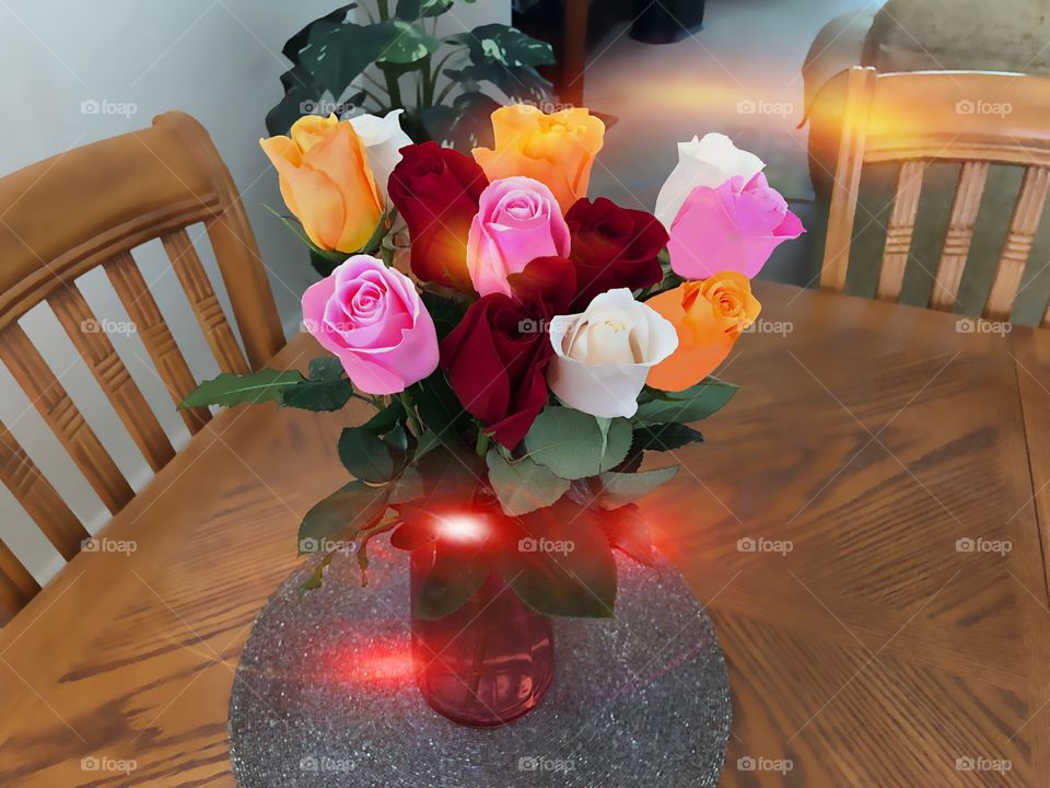 Sunbeams on a multicolored rose bouquet.