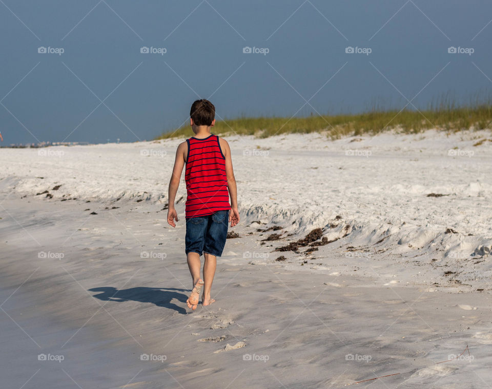 Boy walking on the beach