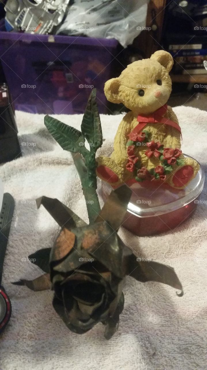 A metal Rose with a glass Bear