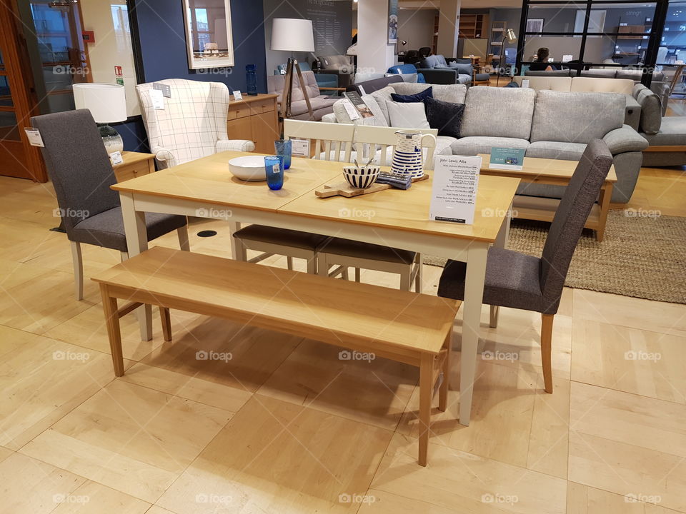 Dining table with chairs and benches at Peter Jones Sloane square Chelsea King's road London