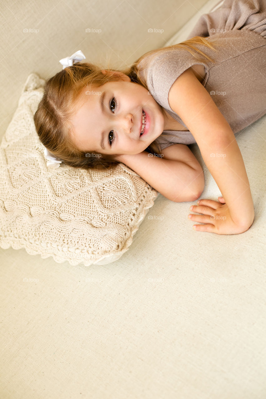 Elevated view of girl lying on cushion