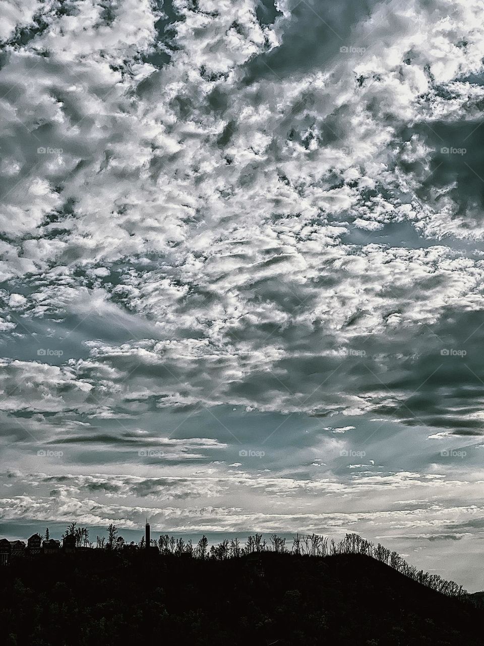 Clouds and sky in Tennessee, the big sky near Dollywood, shadow of the forest against a bright sky with clouds, outlines of nature, blue skies and tree lines, wilderness in Tennessee