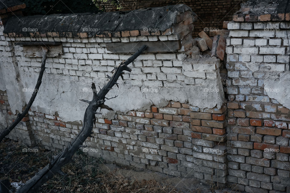 falling brick fence with props