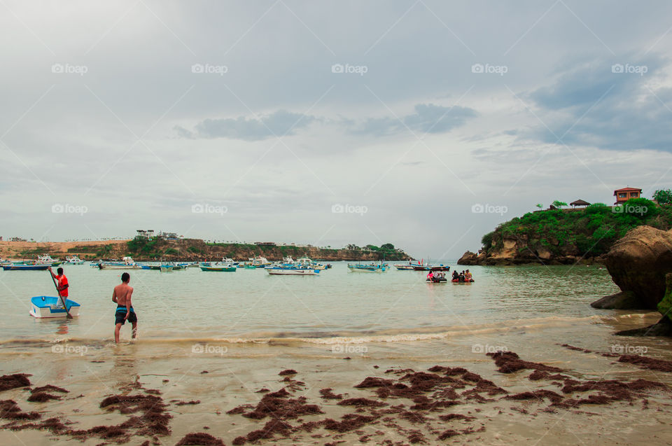 Boats and people on a beach