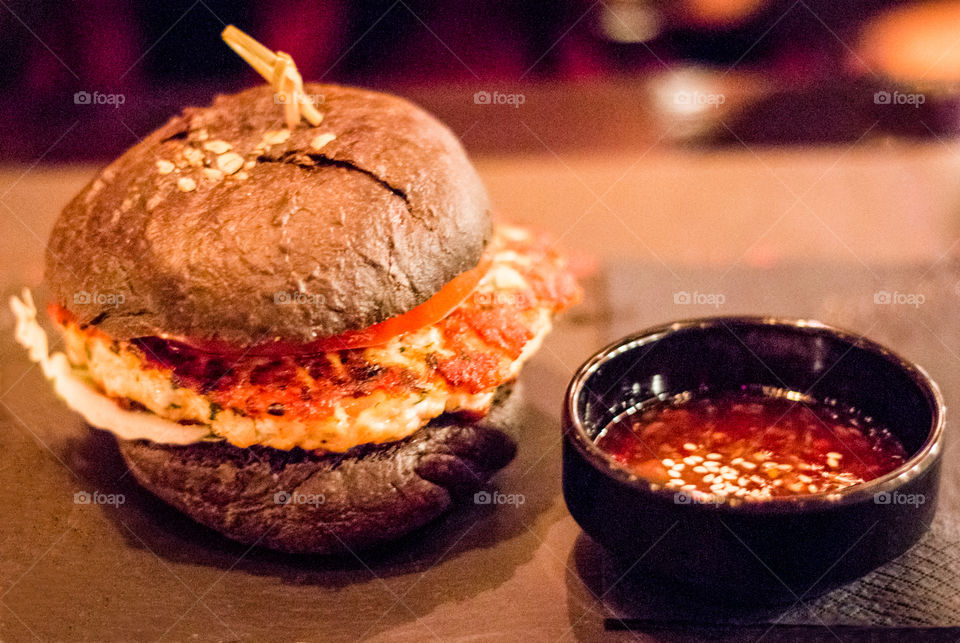 Fast Food Hamburger With Dip Sauce In Black Bowl
