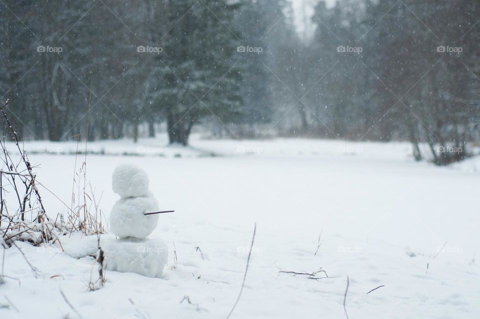 Snowman in forest. Winter activity. Winter background 