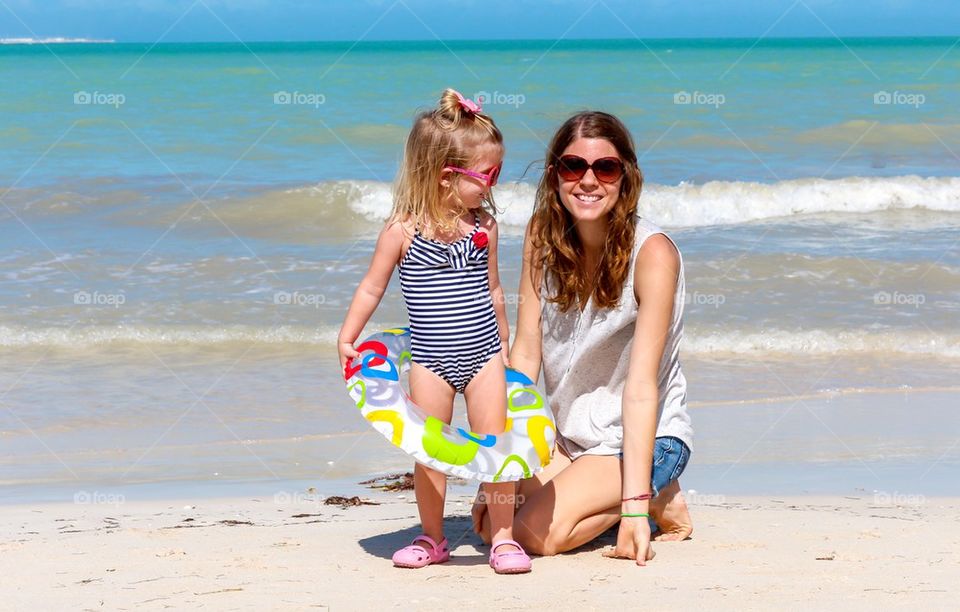 Mom and child having fun at the beach