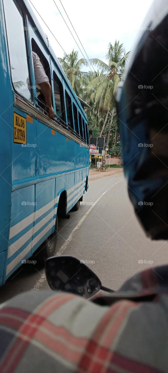 back side photo of blue colour public transport bus in rural areas