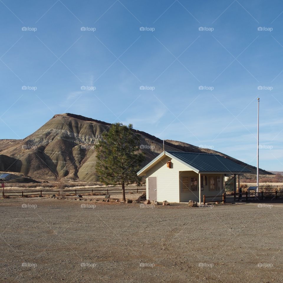 The information building at the Painted Hills with a beautiful multi-layered textured and detailed hill in the background on a sunny winter afternoon. 